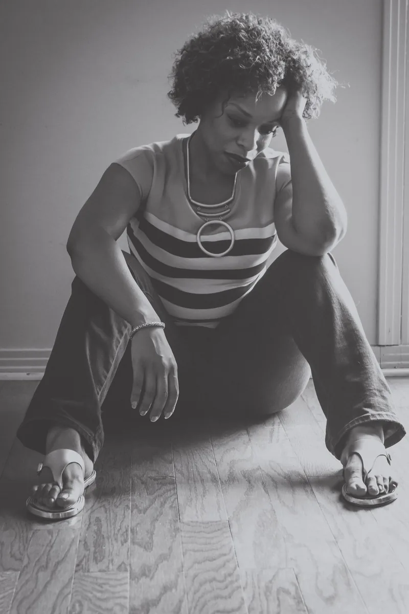 Clea McLemore, seated in thought, in black and white